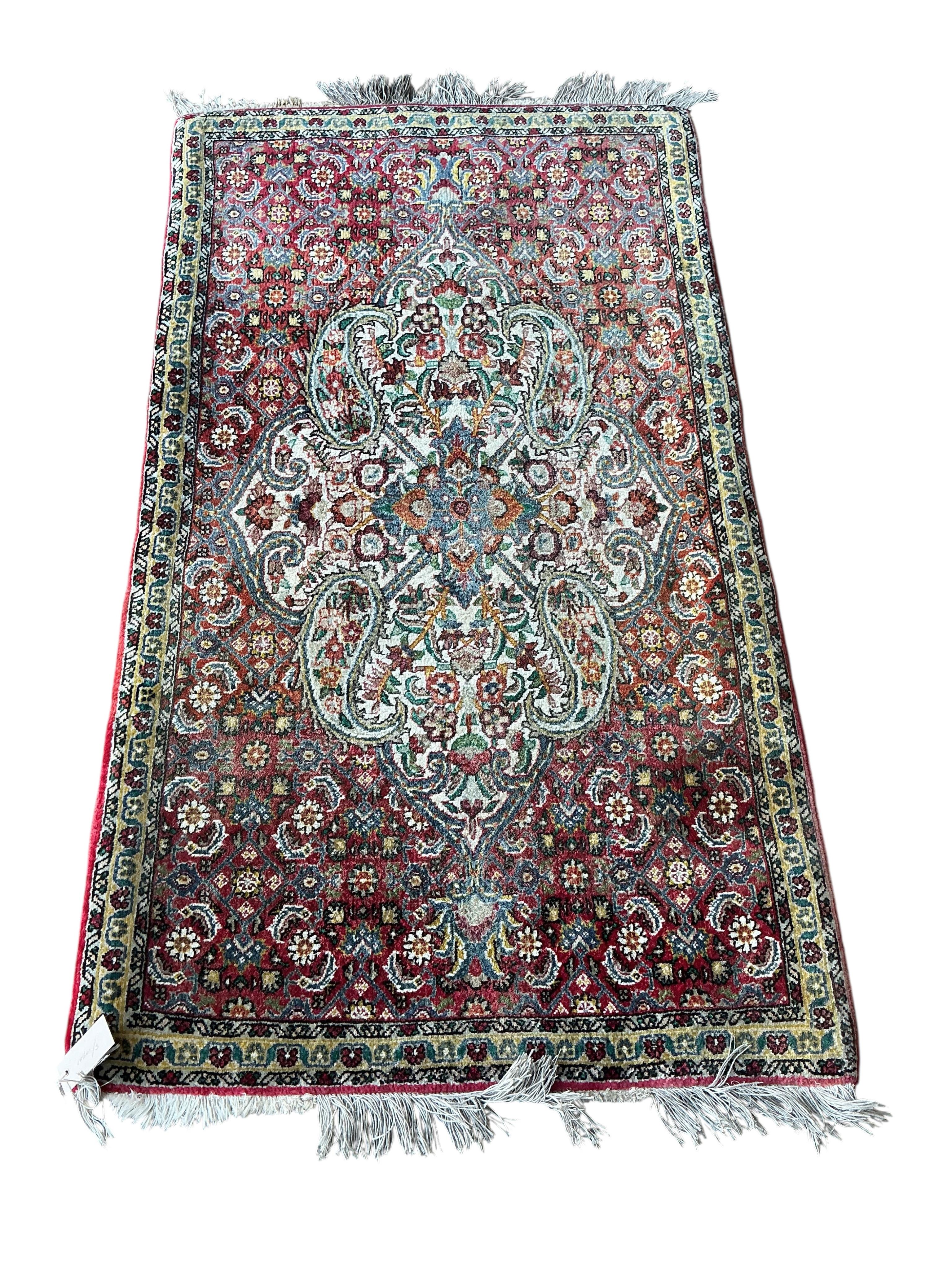 A North West Persian red ground medallion rug, 134 x 78cm